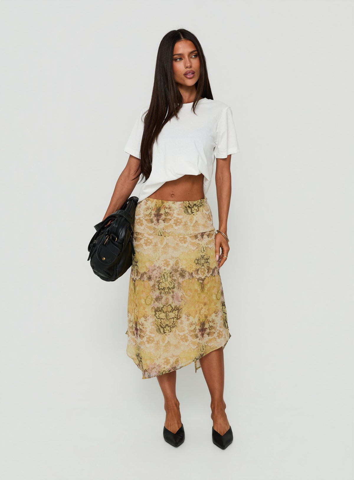 Showcasing the Daphene Asymmetrical Midi Skirt Multi in womens-skirts with relaxed fit, frayed hem, and abstract print front view of model wearing Princess Polly