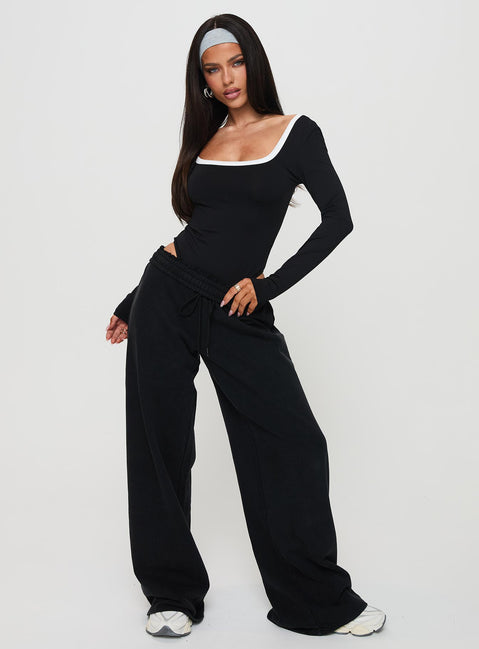 side view of model wearing Princess Polly Ender Contrast Trim Bodysuit Black Long Sleeve Tops Bodysuit 