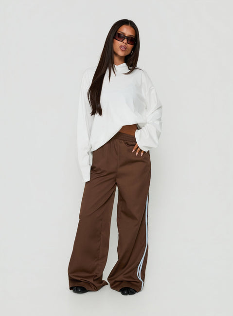 Discover the Fielder Track Pants Brown / Blue womens-regular-pants with high-rise front view of model wearing Princess Polly