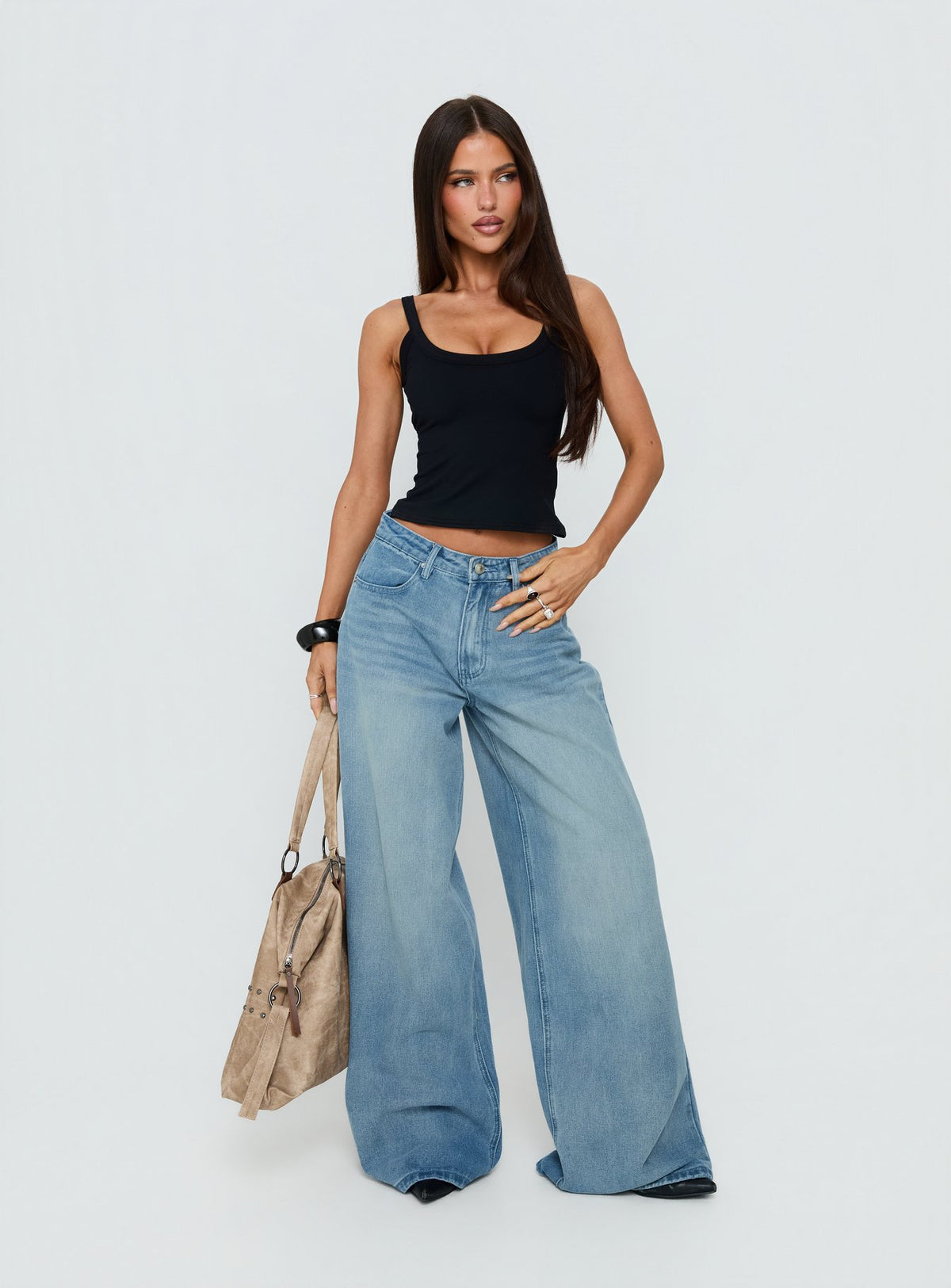 Showcasing the Naylor Mid Rise Wide Leg Jeans Light Wash Denim Tall in womens-jeans with mid-rise front view of model wearing Princess Polly
