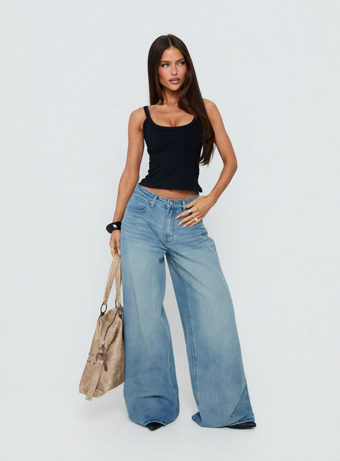 Showcasing the Naylor Mid Rise Wide Leg Jeans Light Wash Denim Tall in womens-jeans with mid-rise front view of model wearing Princess Polly