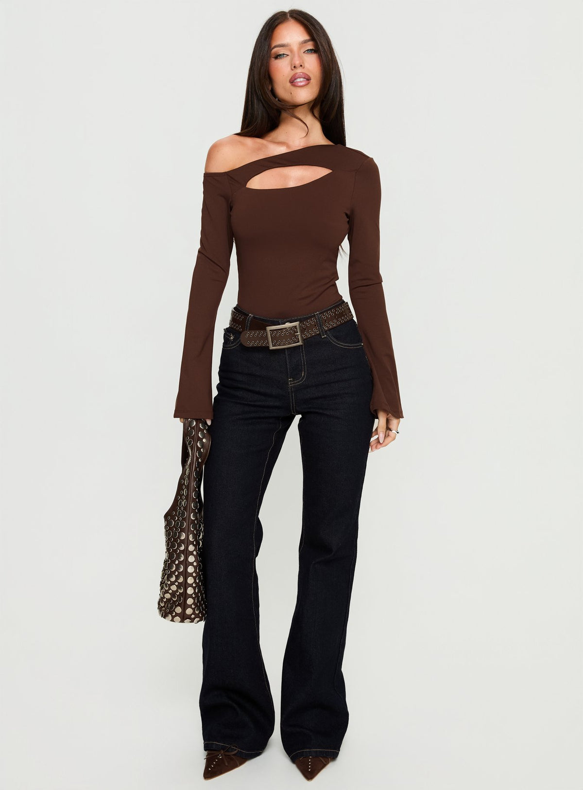 side view of model wearing Princess Polly Raissa Cut Out One Shoulder Bodysuit Brown Long Sleeve Tops Bodysuit 