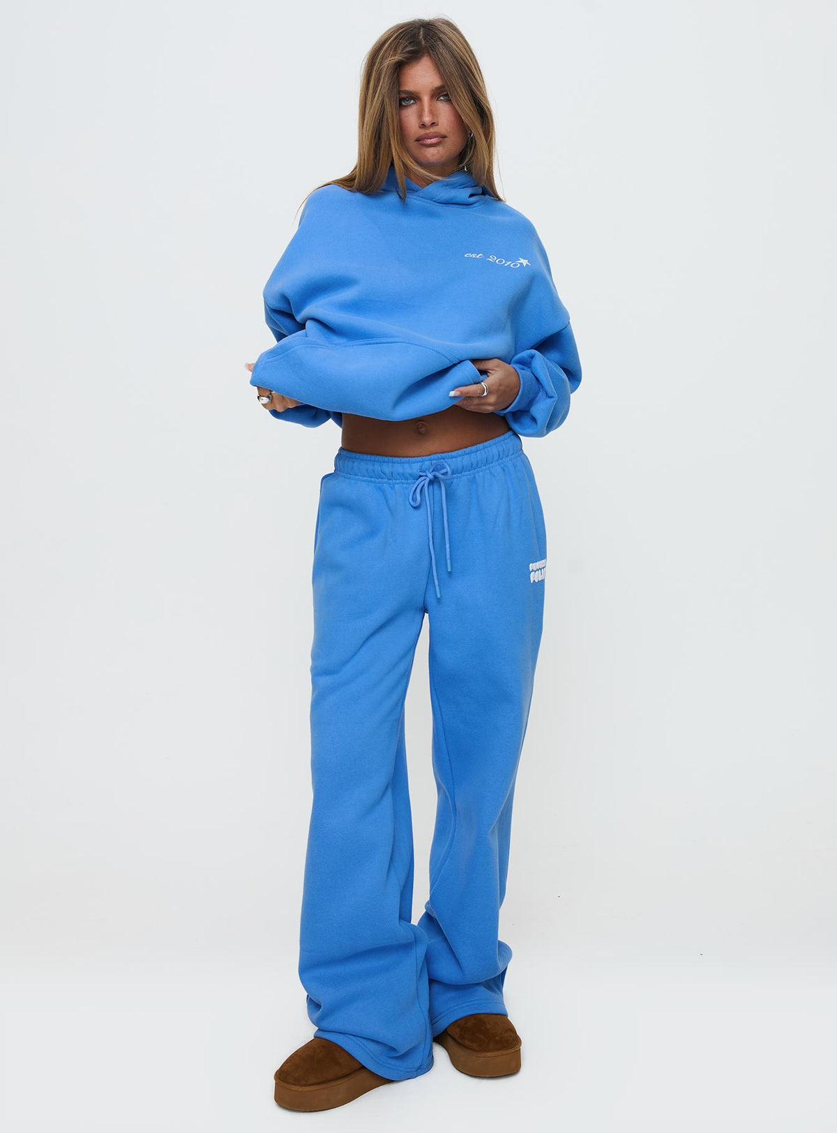 front view of model wearing Princess Polly Princess Polly Wide Leg Track Pant Bubble Text Blue High Rise Pants Pants 