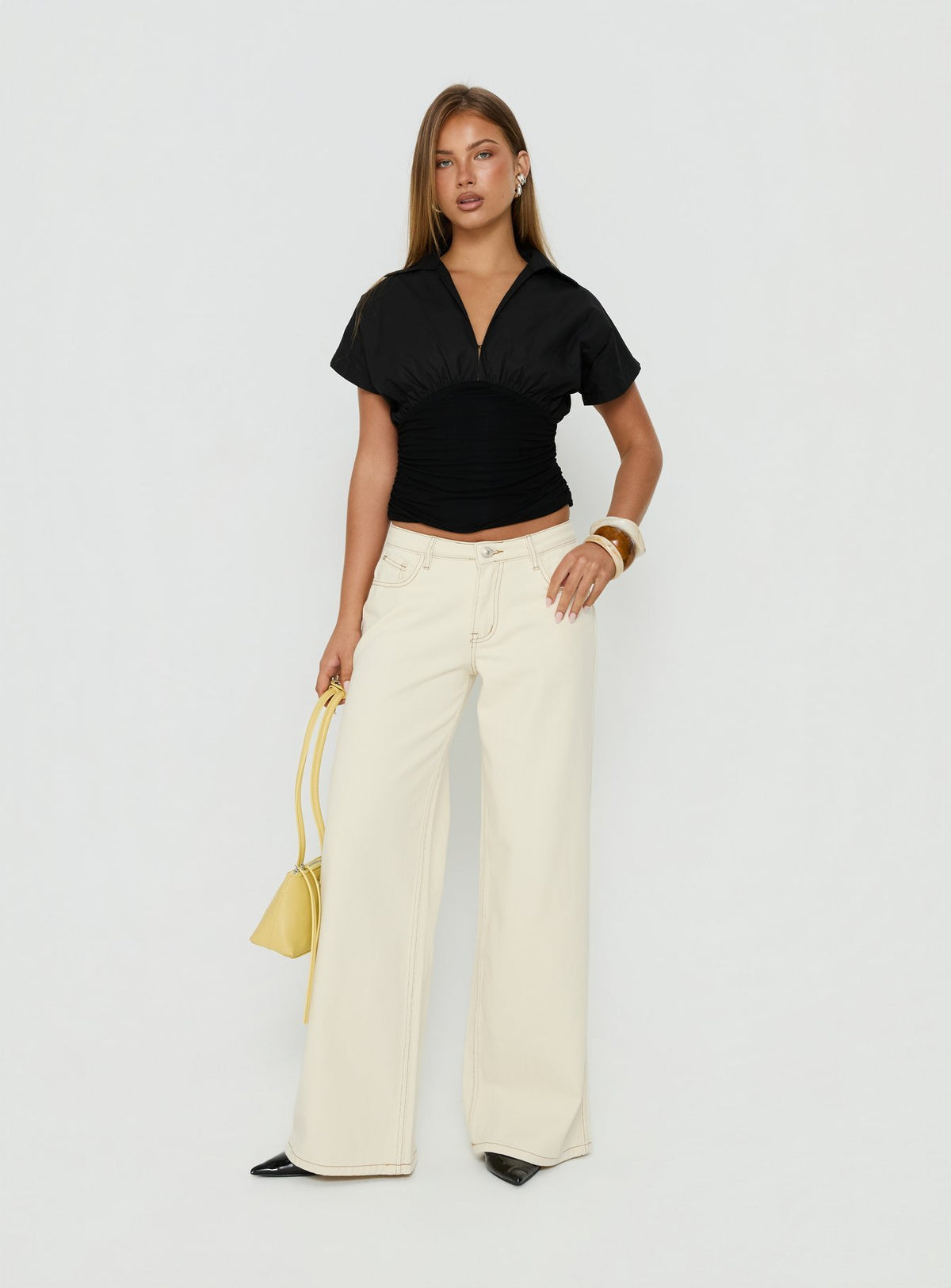 Discover the Ramos Low Rise Wide Leg Jeans in Cream front view of model wearing