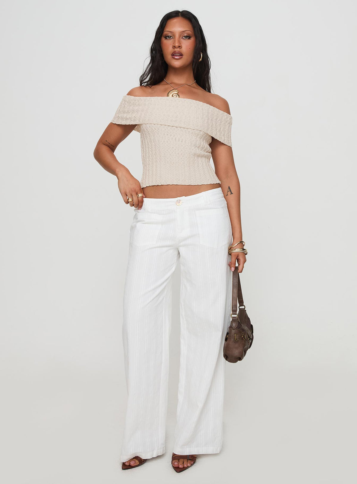 front view of model wearing Princess Polly Vendi Low Rise Pant White Petite Low Rise Pants 