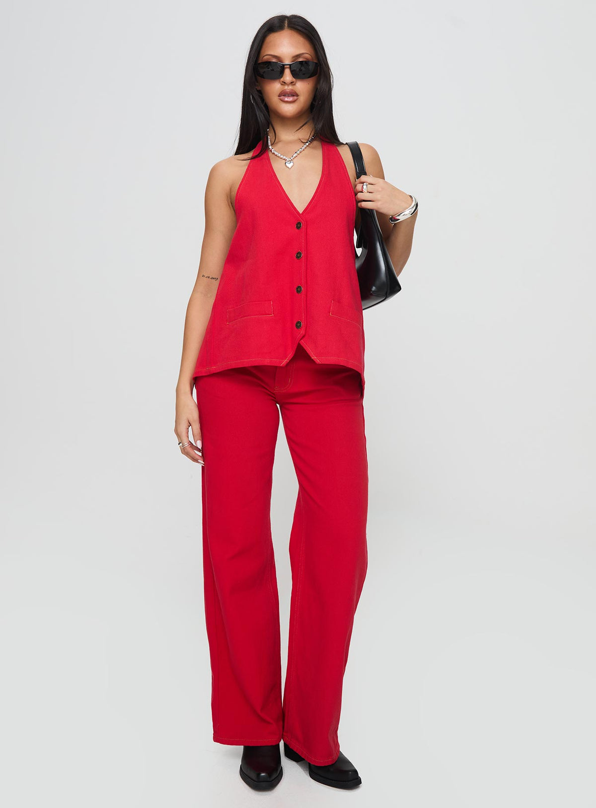 front view of model wearing Princess Polly Top Model Jeans Red Mid Rise Jeans Jeans 