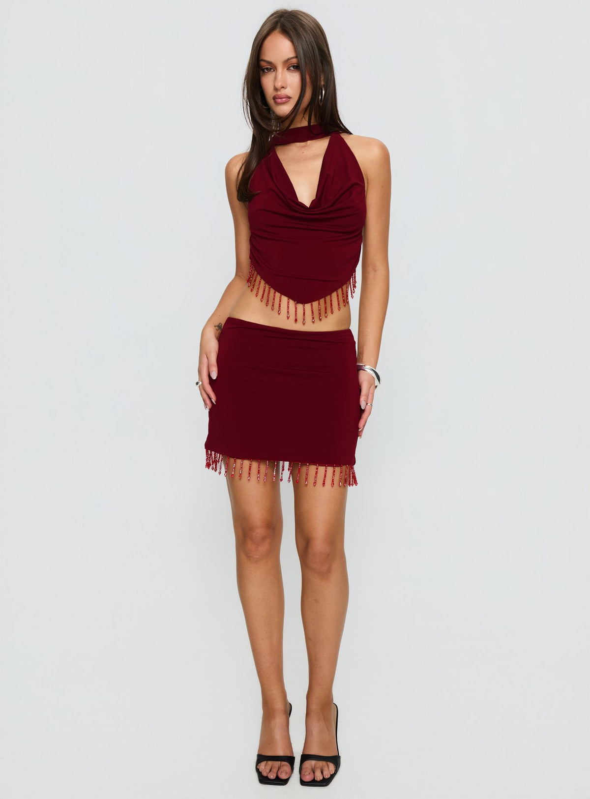   side view of model wearing Princess Polly Ginah Bead Tassel Mini Skirt Red Mini Skirts Skirts 