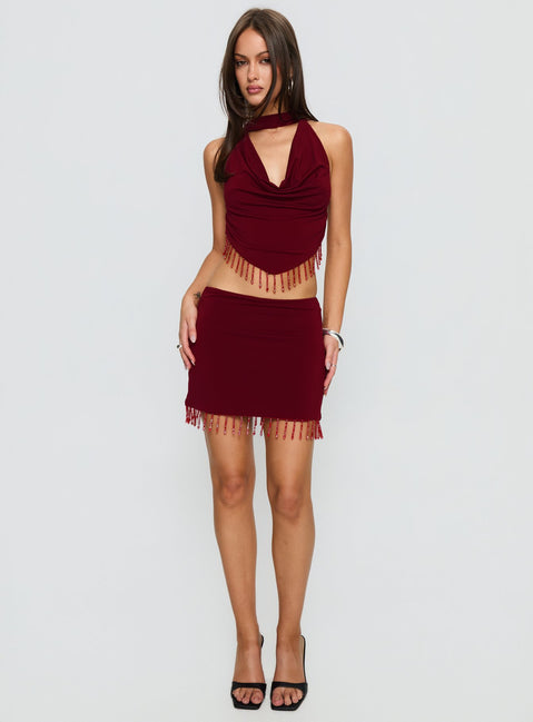   side view of model wearing Princess Polly Ginah Bead Tassel Mini Skirt Red Mini Skirts Skirts 