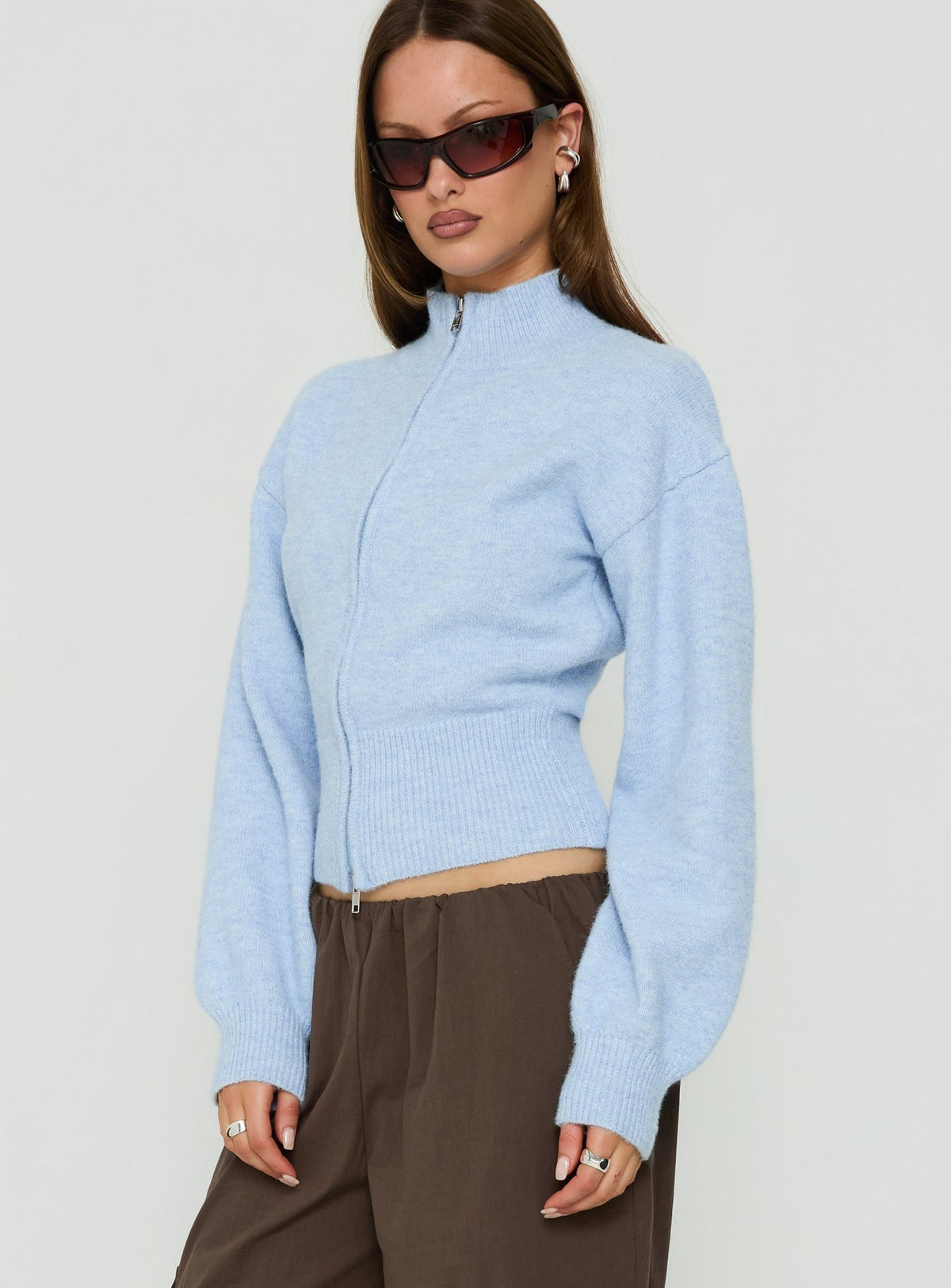 Crafted with the Agneta Zip Through Funnel Neck Sweater Blue womens-jumpers featuring short length side view of model wearing Princess Polly
