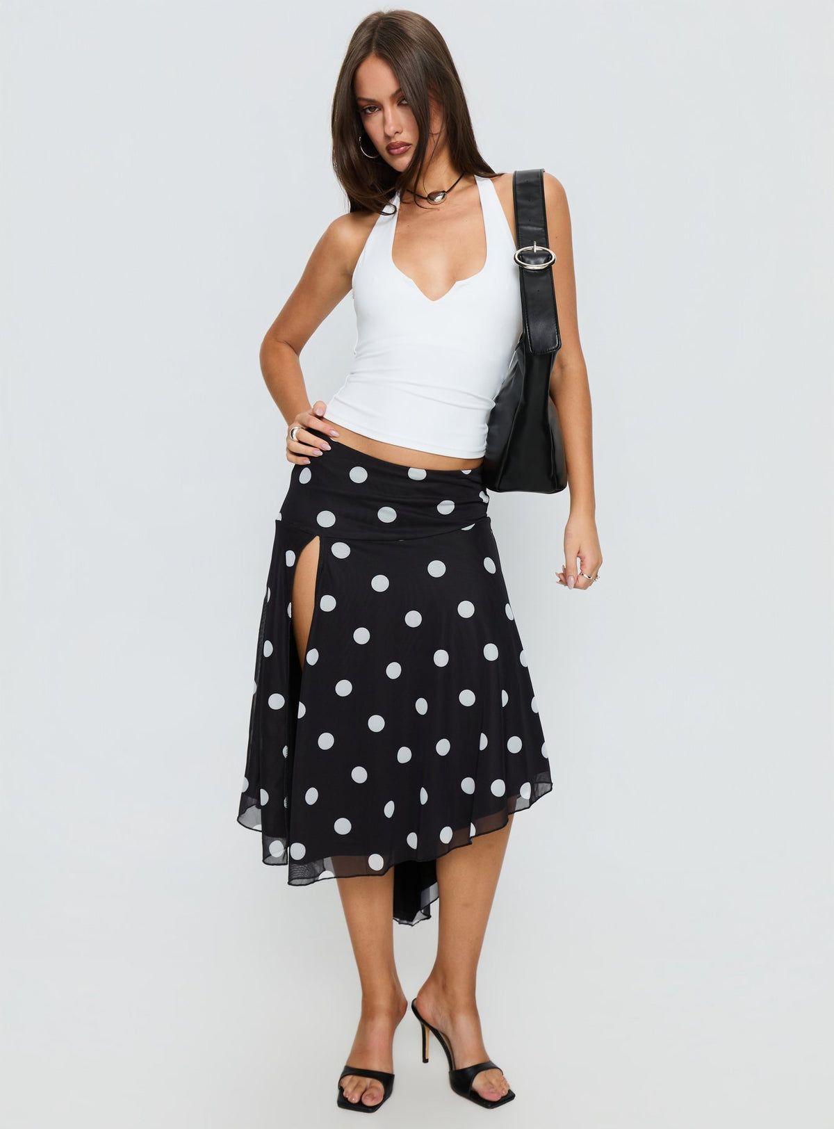   side view of model wearing Princess Polly Dulciana High Split Asymmetrical Midi Skirt Black / Polka Dot Midi Skirts Skirts 