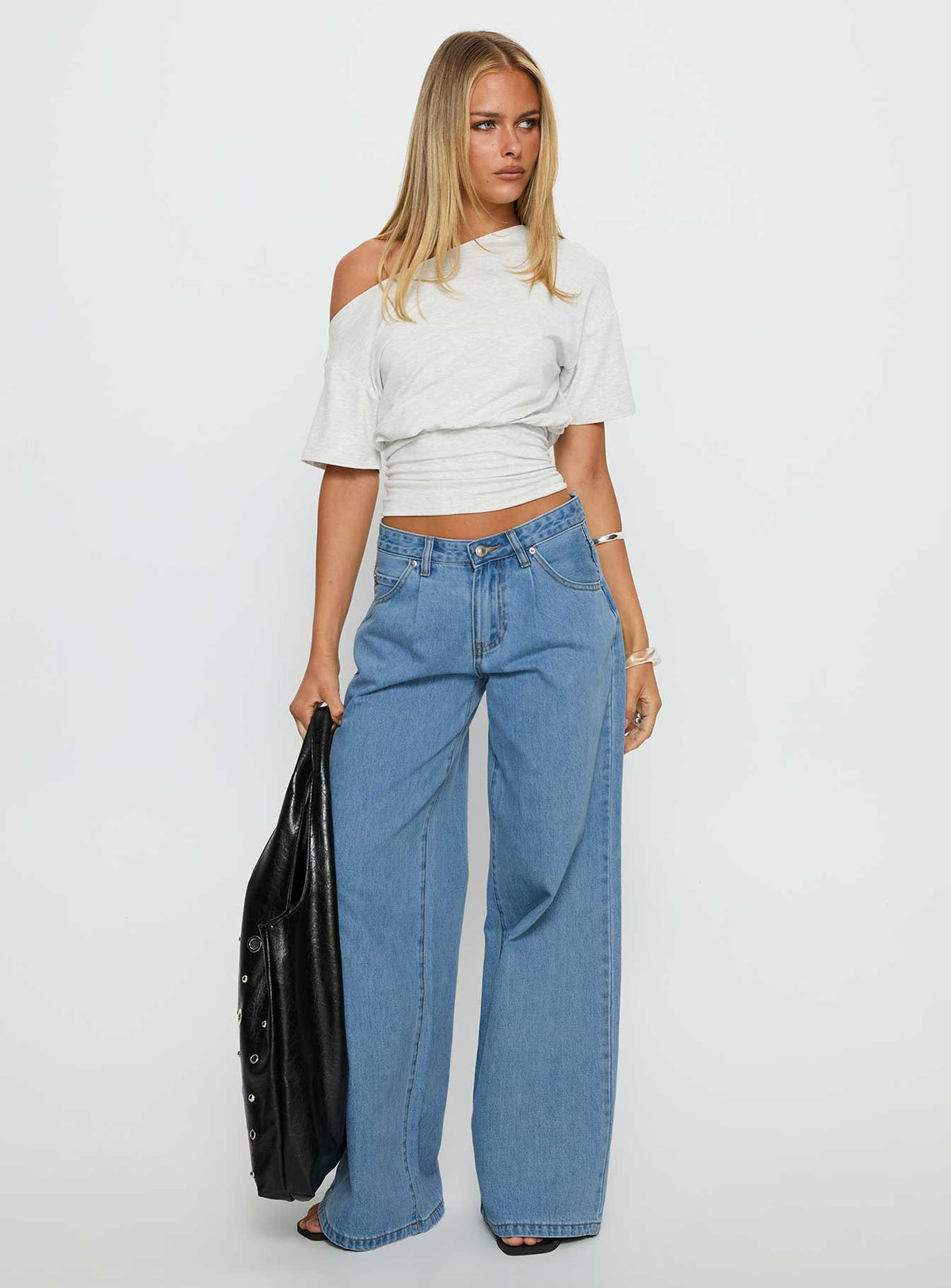 front view of model wearing Princess Polly Supercut Low Rise Baggy Pleat Jeans Light Blue Wash Low Rise Jeans Jeans 