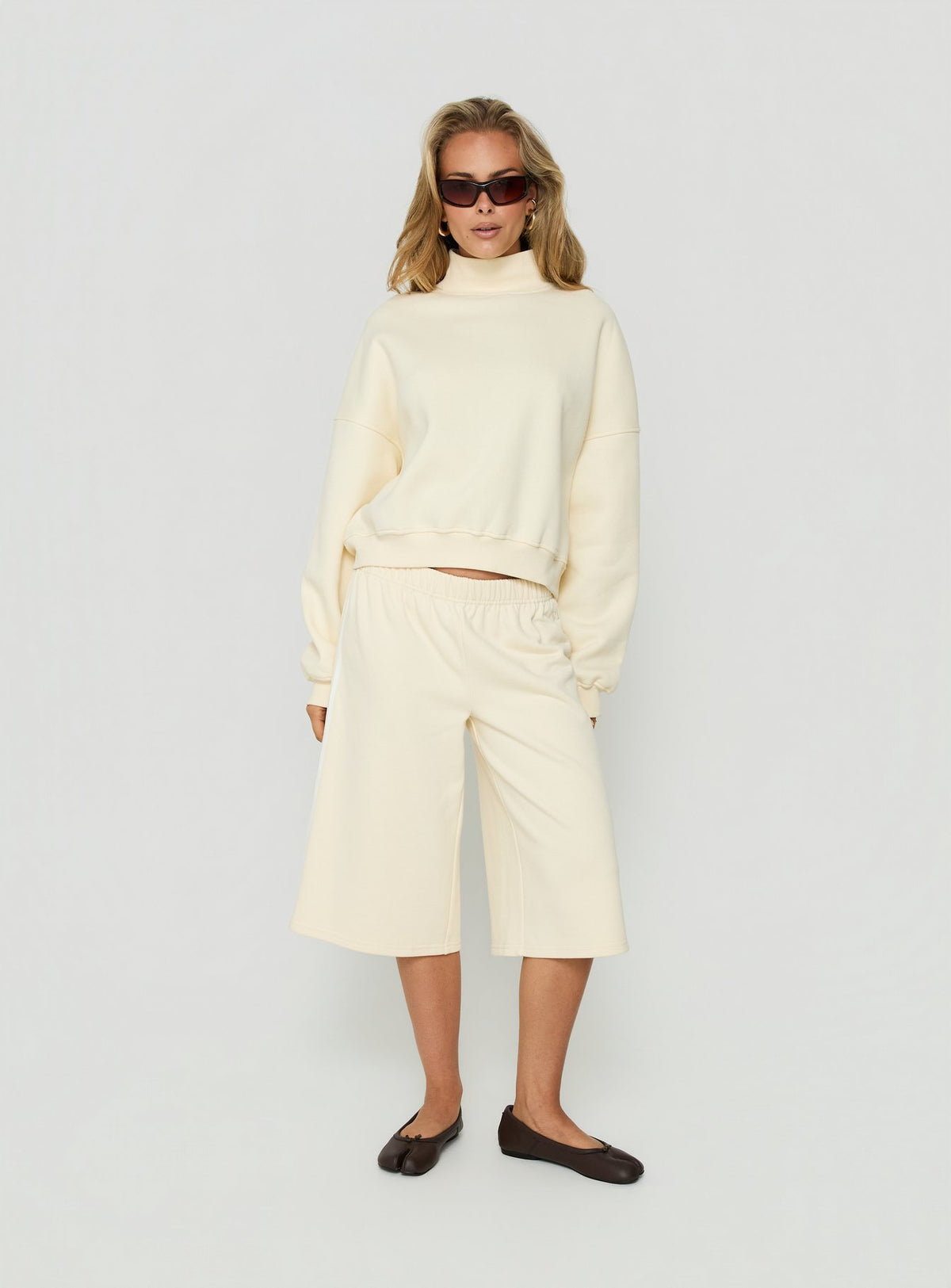 Showcasing the Anyya Funnel Neck Crew Jumper Cream in a short womens jumper front view of model wearing Princess Polly