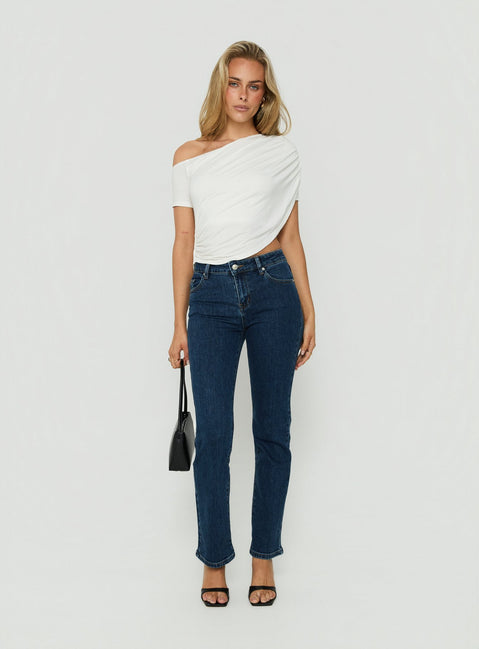 Model wearing Harpor Mid Rise Slim Skinny Jean Mid Blue Wash womens-jeans with belt detail view of model wearing Princess Polly