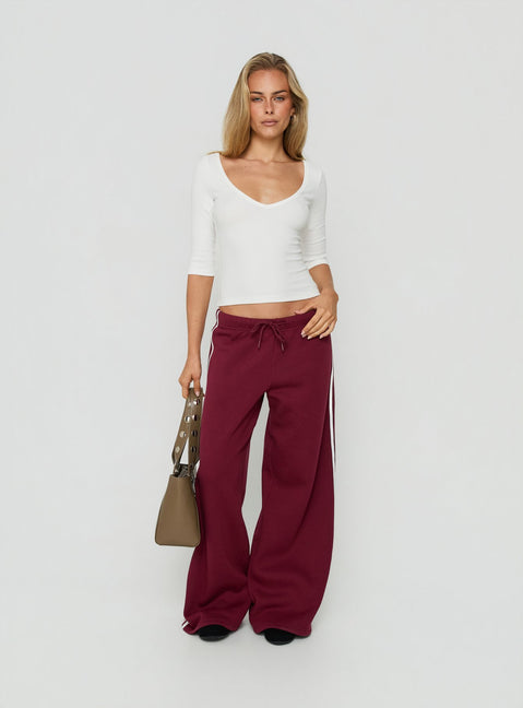 Crafted from cherry fabric, the Kennah Wide Leg Sweat Pants in womens-regular-pants with mid-rise waist front view of model wearing Princess Polly