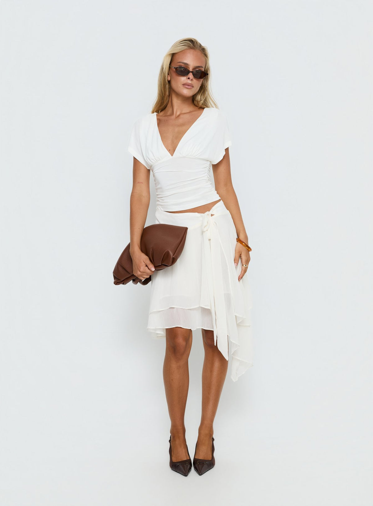 Crafted in ivory, the Ophella Tie Waist Chiffon Midi Skirt Cream womens-skirts with asymmetry and layered details product Princess Polly