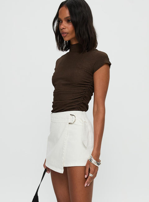  side view of model wearing Princess Polly Elinora Wrap Mini Skirt White Mini Skirts Skirts 