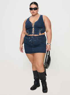   side view of model wearing Princess Polly Popular Low Rise Mini Skirt Mid Blue Wash Curve Mini Skirts Skirts 