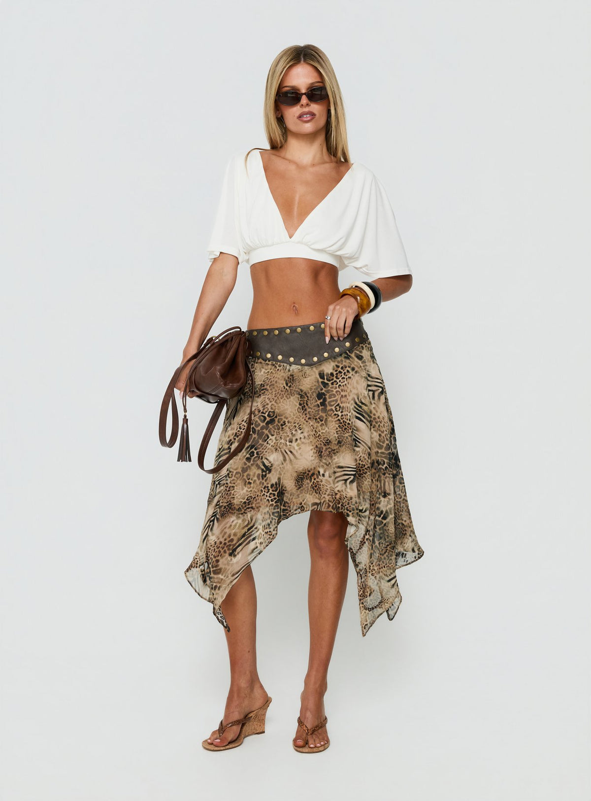 Shop the Dark Mirage Asymmetrical Midi Skirt in Leopard print with relaxed fit and belt detail front view of model wearing Princess Polly