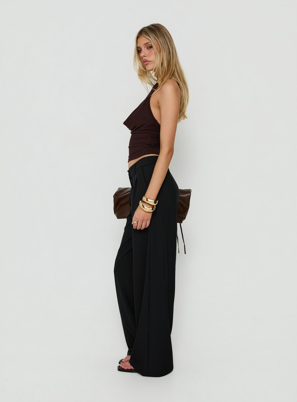 Explore the Archer Mid Rise Baggy Pants Black in womens-regular-pants side view of model wearing Princess Polly