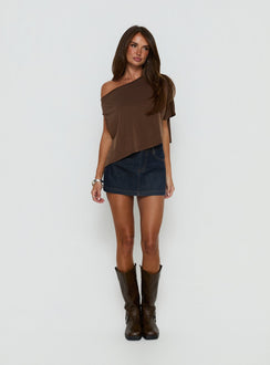   side view of model wearing Princess Polly Nicolina Low Rise Denim Mini Skirt Raw Denim Mini Skirts Skirts 