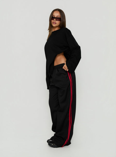 Crafted with Fielder Track Pants Black / Red in womens-regular-pants featuring mid-rise side view of model wearing