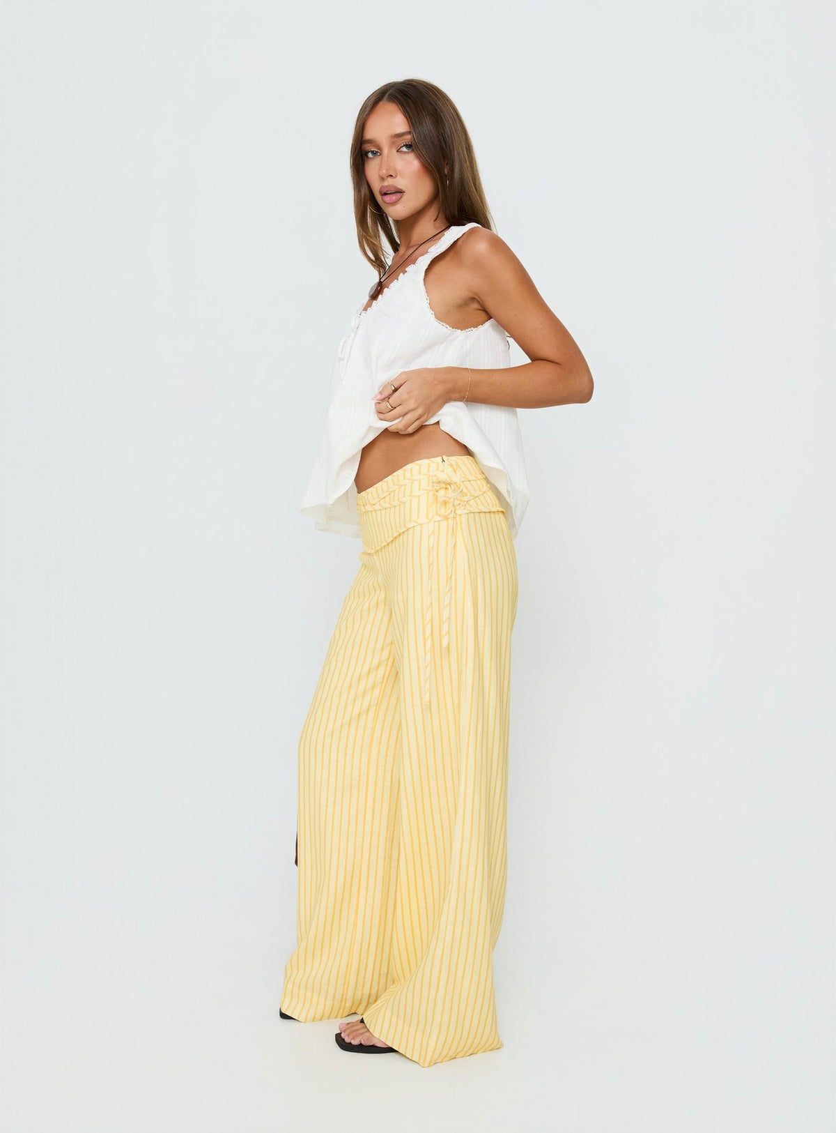 side view of model wearing Princess Polly Silver Moon Pants Yellow Stripe Low Rise Pants Pants 