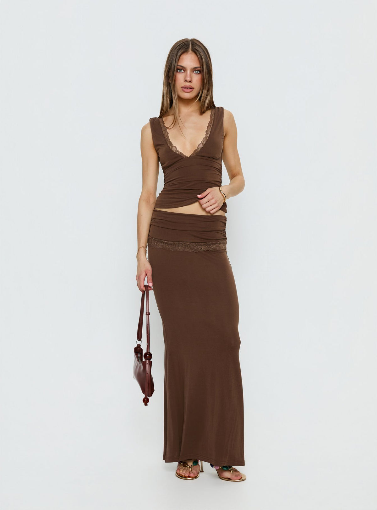   side view of model wearing Princess Polly Zespri Jersey Maxi Skirt Brown Maxi Skirts Skirts 