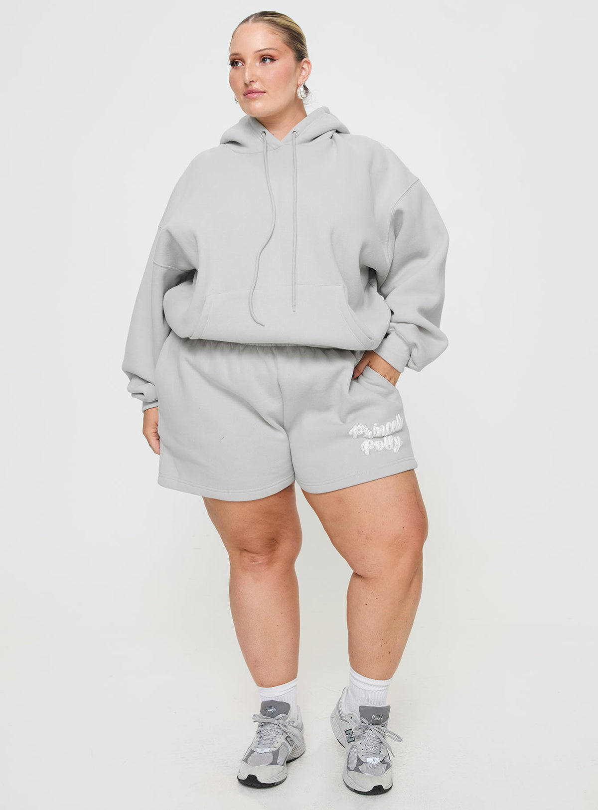 front view of model wearing Princess Polly Princess Polly Hooded Sweatshirt Puff Text Grey Curve Jumpers 