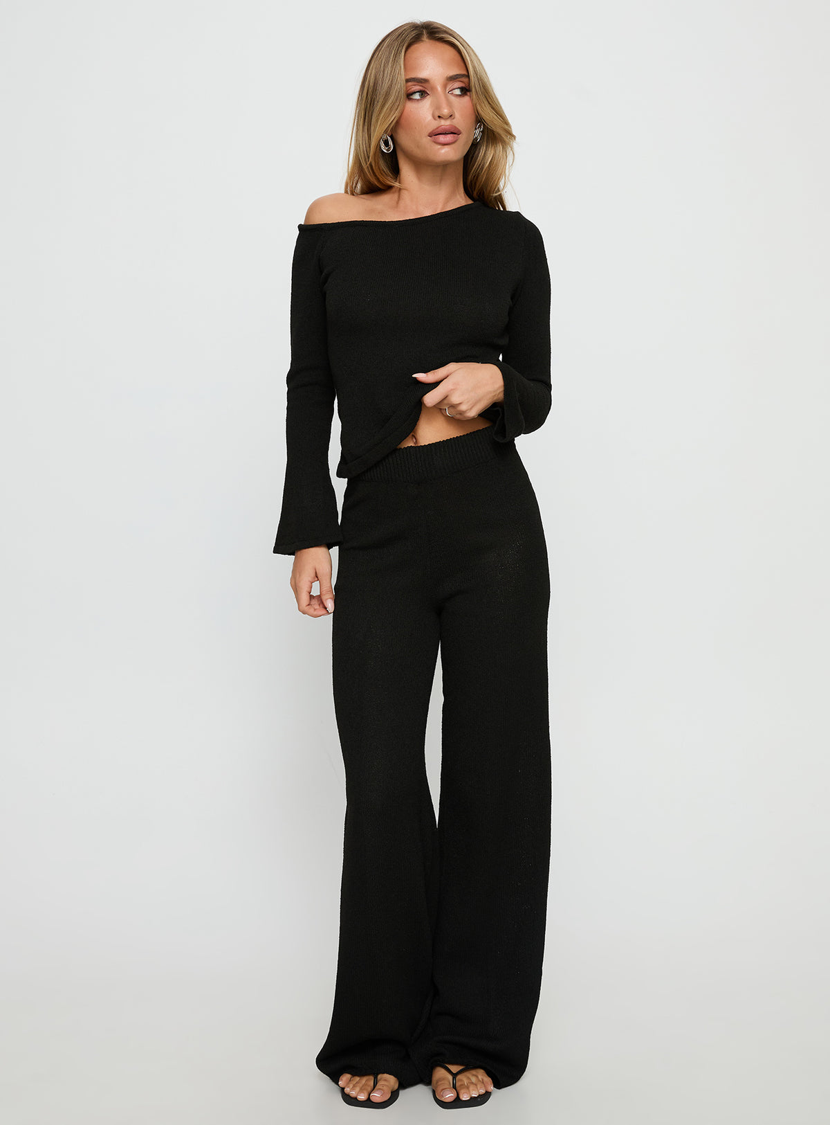 side view of model wearing Princess Polly Jaede Off Shoulder Knit Sweater Black Cropped Jumpers Jumpers 