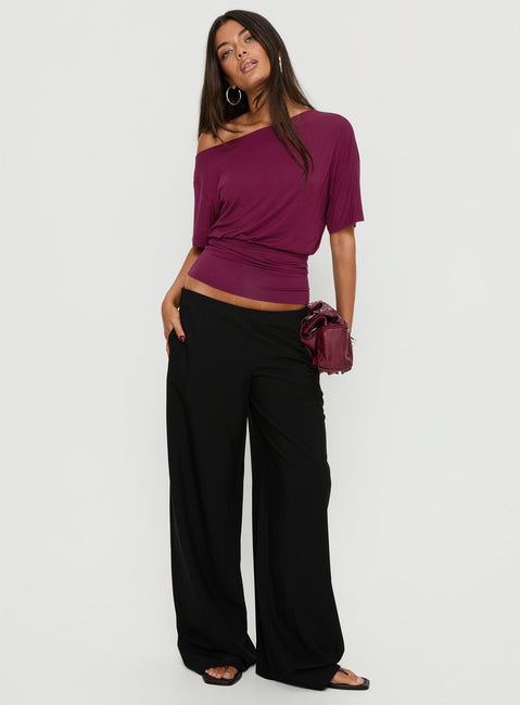 Presenting the Khane Low Rise Wide Leg Pant Black Petite in womens-regular-pants back view of model wearing