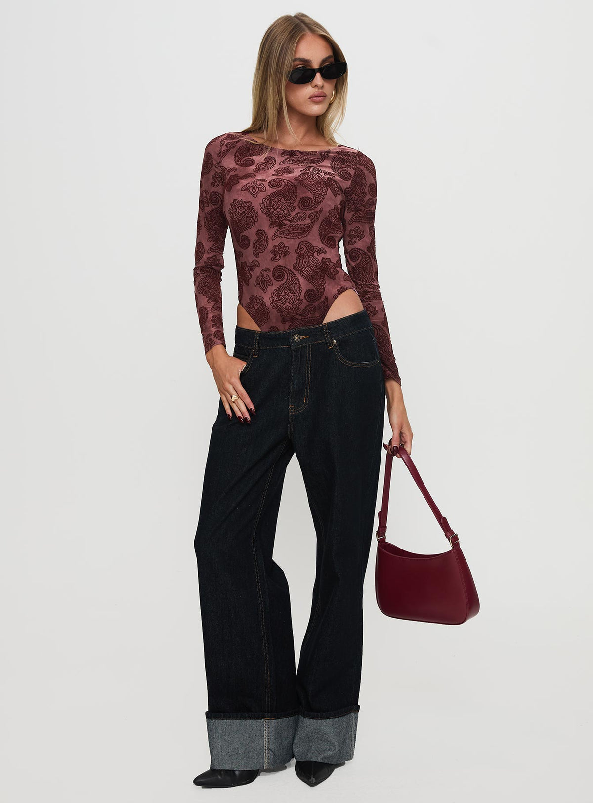 side view of model wearing Princess Polly Spruce Bodysuit Red Paisley Long Sleeve Tops Bodysuit 