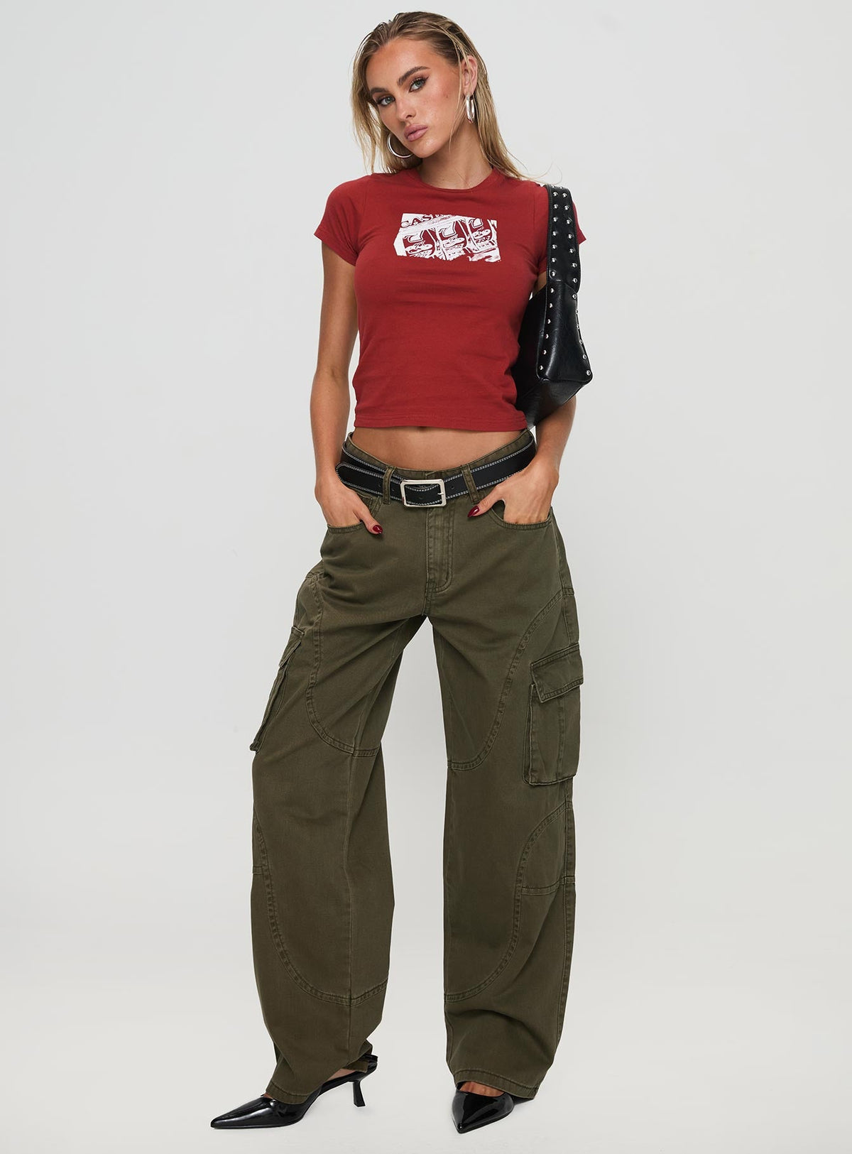 front view of model wearing Princess Polly Ahstin Mid Rise Straight Leg Cargo Jeans Green Petite Mid Rise Jeans Jeans 