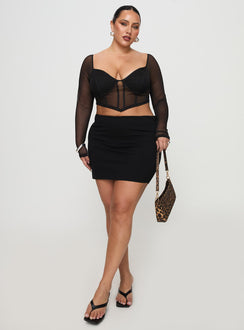  side view of model wearing Princess Polly Karley Low Waist Mini Skirt Black Curve Mini Skirts Skirts 