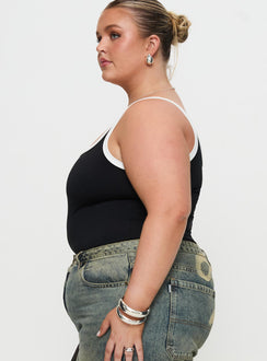 side view of model wearing Princess Polly Astrea Bodysuit Black / White Curve Sleeveless Bodysuit 