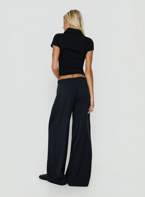 Styled Yuzima Micro Belt Pleated Pants Navy Pinstripe in womens regular pants with mid-rise back view of model wearing Princess Polly