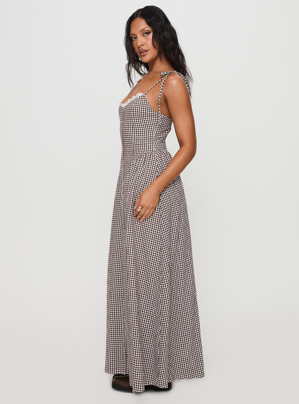 side view of model wearing Princess Polly Dalanie Tie Strap Maxi Dress Brown Gingham Scoop Neck 