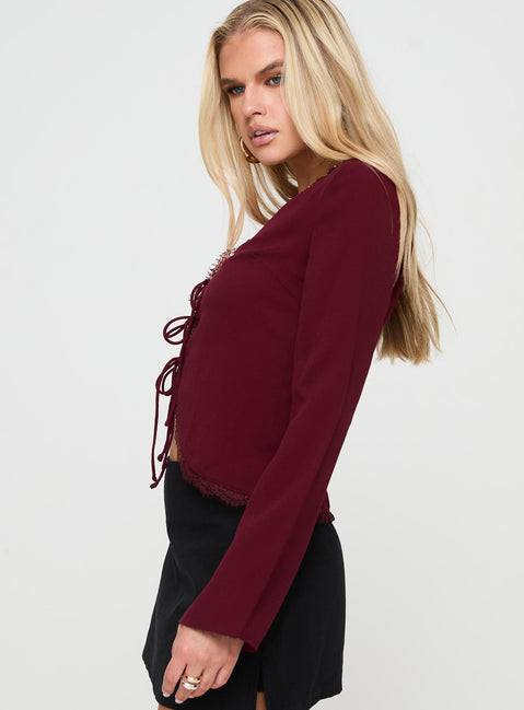 side view of model wearing Princess Polly Hagner Long Sleeve Top Burgundy Full Sleeves V-Neck 