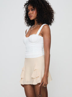   side view of model wearing Princess Polly Foalie Ruffle Mini Skirt Beige Mini Skirts Skirts 