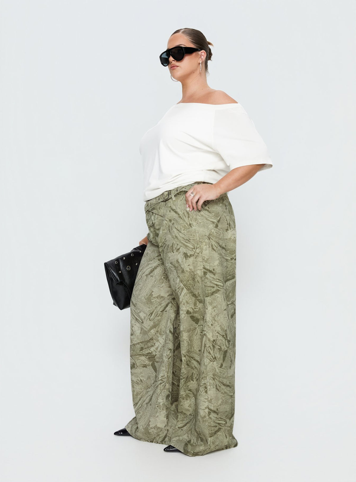 side view of model wearing Princess Polly Mckinley Mid Rise Wide Leg Jeans Camouflage Curve Mid Rise Jeans Jeans 