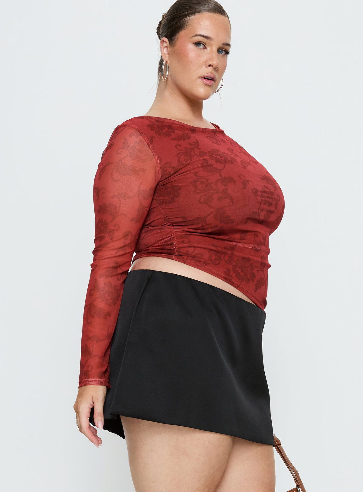   side view of model wearing Princess Polly Nadya Satin Tailored Mini Skirt Black Curve Skirts 