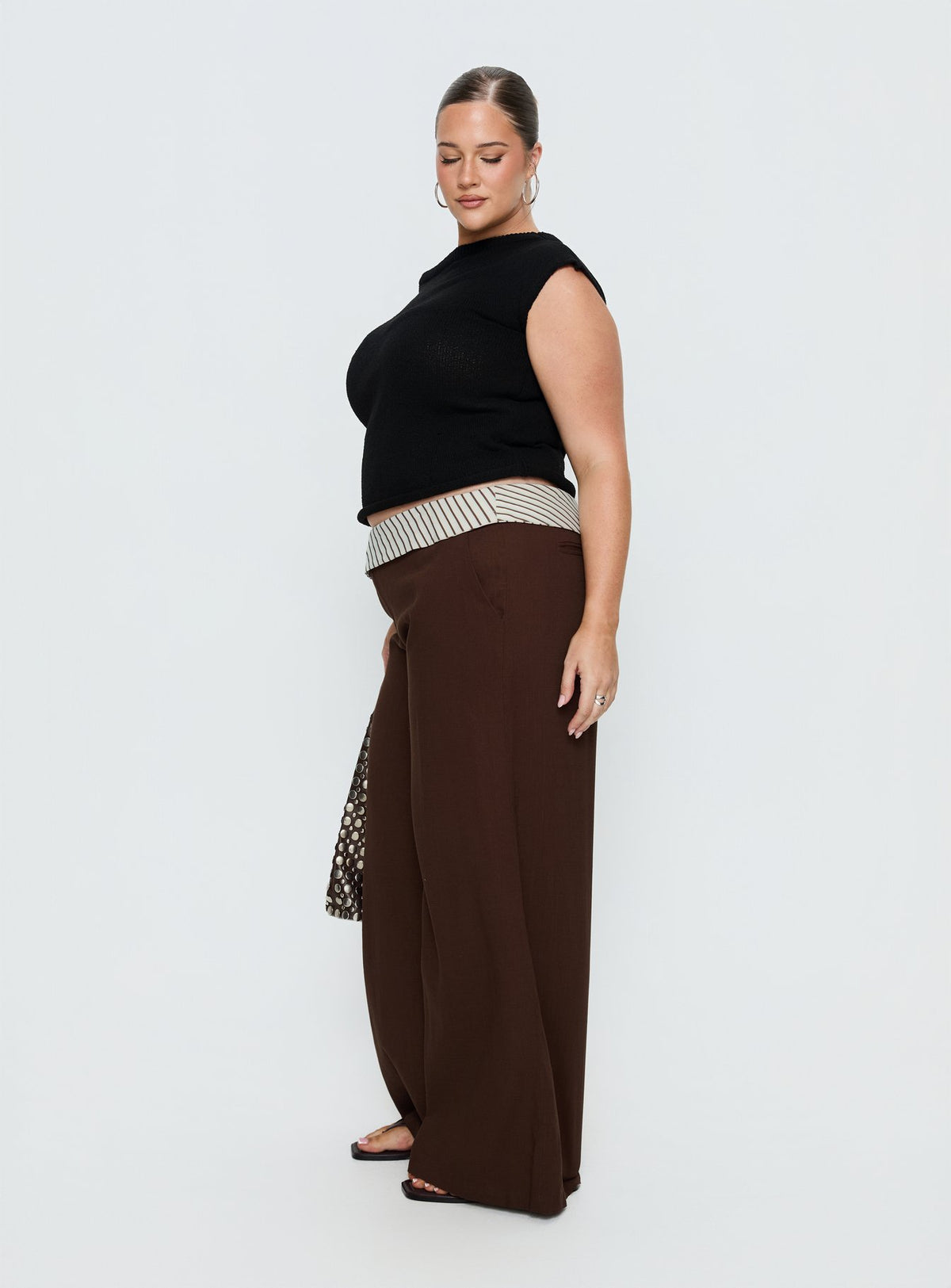 side view of model wearing Princess Polly Past Life Fold Over Waistband Pant Brown / Stripe Curve Mid Rise Pants Pants 