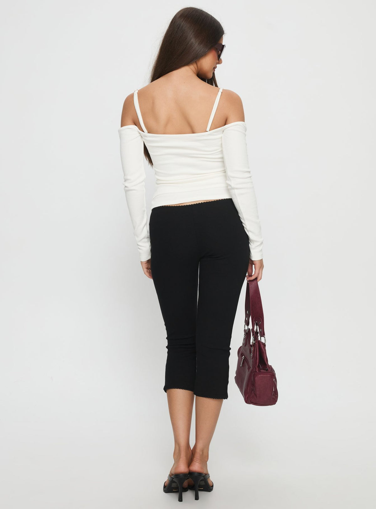 back view of model wearing Princess Polly Baseline Rib Capri Pants Black Tall Mid Rise Pants Pants 