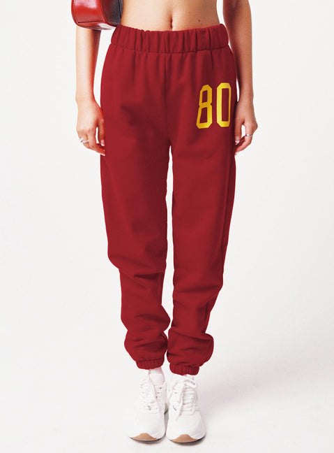 side view of model wearing Princess Polly USC Sweatpants Cardinal Red / White Pants 