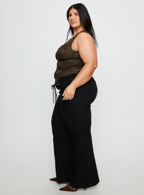 side view of model wearing Princess Polly Twinflame Low Rise Hardware Pants Black Curve Mid Rise Pants Pants 