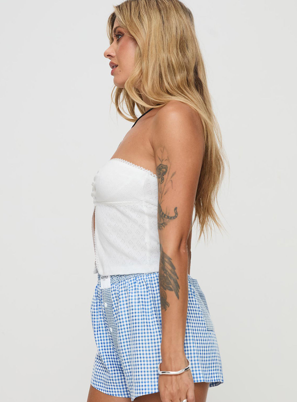side view of model wearing Princess Polly Brekke Strapless Top White Sleeveless Sweetheart 