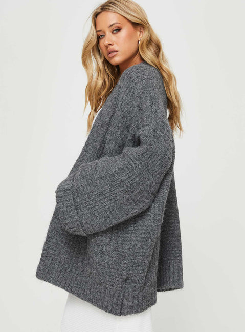 Featuring the Paisleigh Cable Knit Cardigan Charcoal womens jumpers with long length side view of model wearing Princess Polly