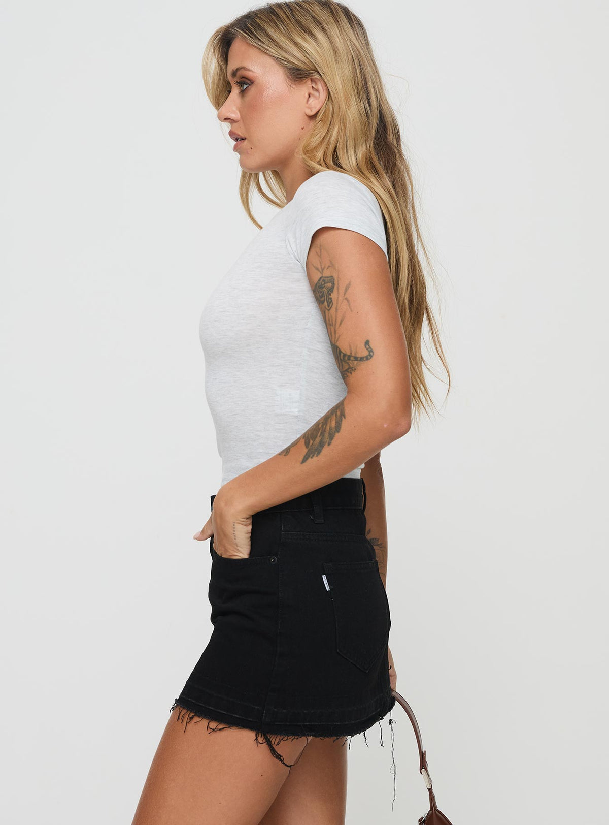   side view of model wearing Princess Polly Aster Mini Skirt Black Mini Skirts Skirts 