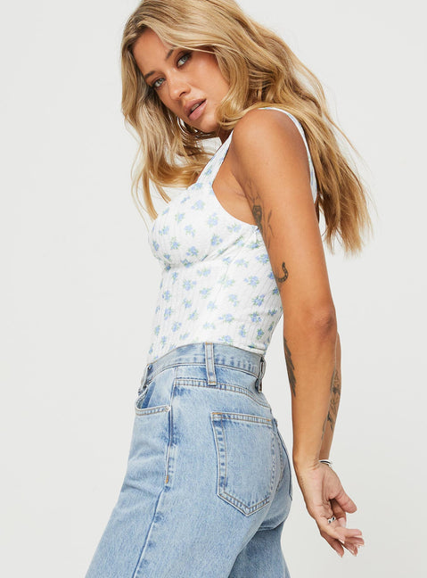 side view of model wearing Princess Polly Lupton Bodysuit White / Blue Floral Sleeveless Bodysuit 
