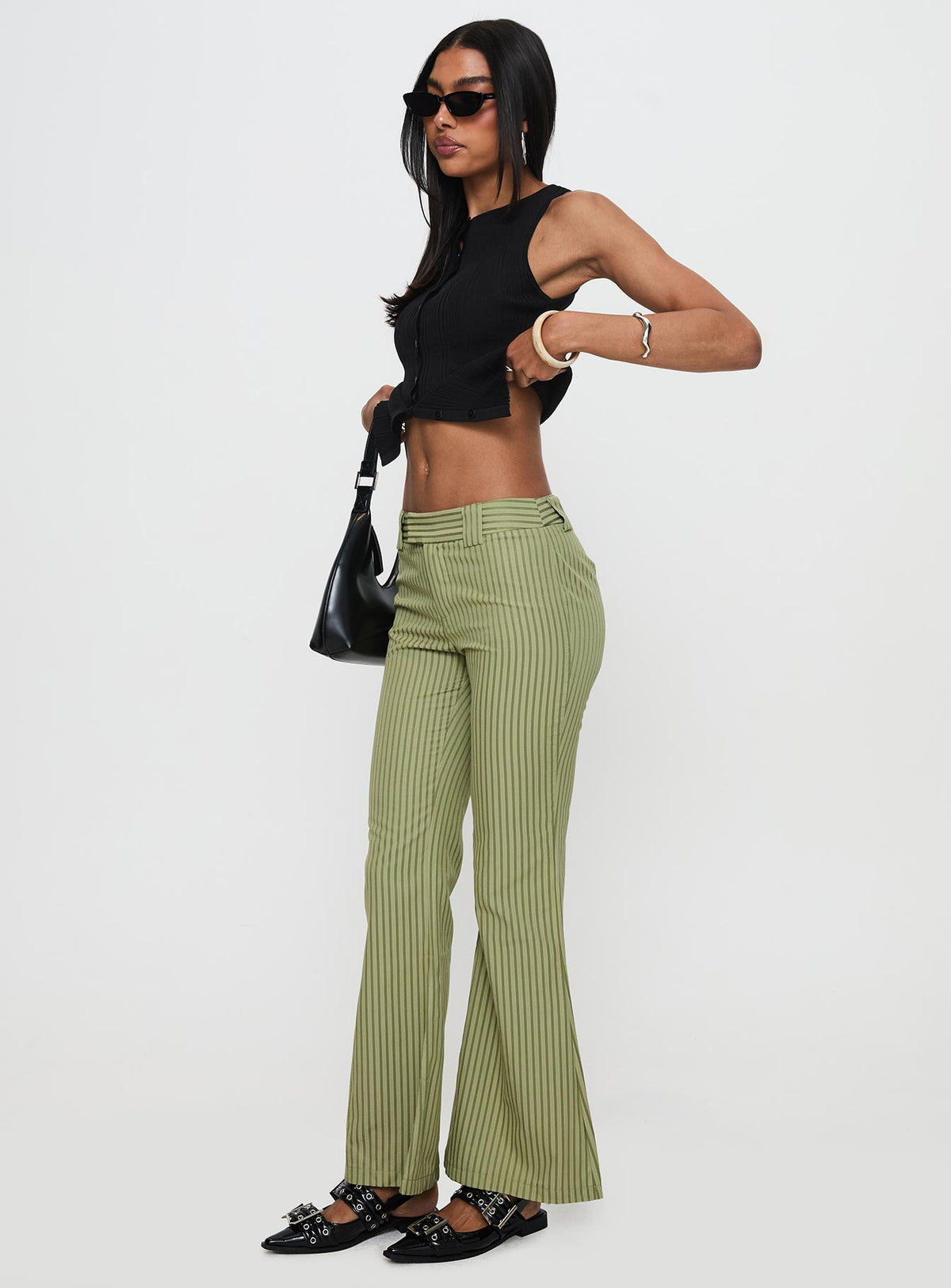 side view of model wearing Princess Polly Jinxed Pant Green Stripe Pants 