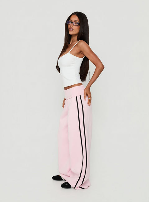 Showcasing Lockie Foldover Baggy Track Pants Pink / Black in womens regular pants with high-rise waist side view of model wearing Princess Polly
